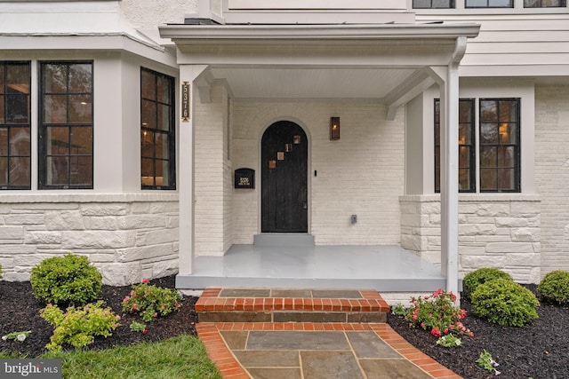 5376 28th St NW, Washington, DC 20015 - property entrance with covered porch, stone siding, and brick siding