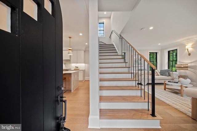 5376 28th St NW, Washington, DC 20015 - staircase featuring wood finished floors, ornamental molding, and recessed lighting