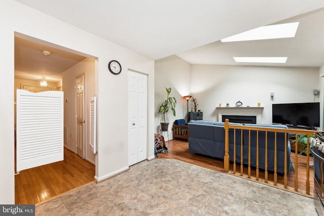 4805 John St, Suitland, MD 20746 - living area with a fireplace, a skylight, and wood finished floors