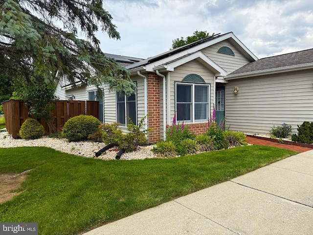 41 Abbey Ct, Carlisle, PA 17015 - view of front of home with brick siding, roof mounted solar panels, and roof with shingles