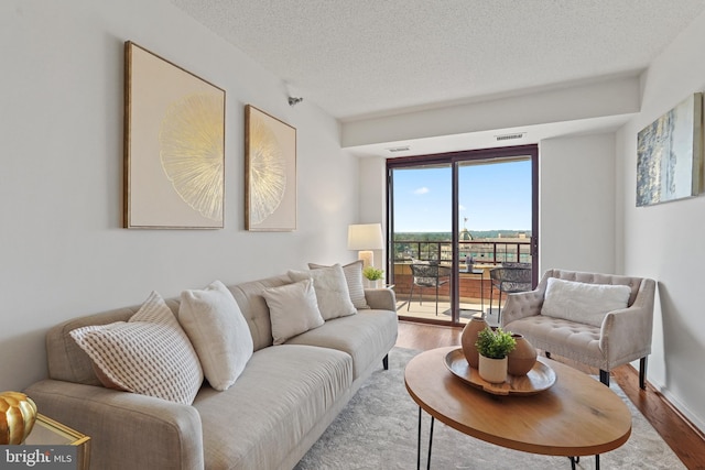 2400 Clarendon Blvd Unit 1015, Arlington, VA 22201 - living room with wood finished floors and a textured ceiling
