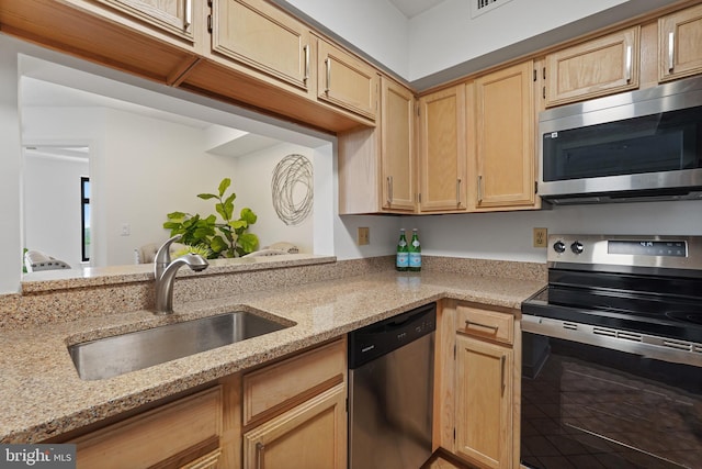 2400 Clarendon Blvd Unit 1015, Arlington, VA 22201 - kitchen featuring stainless steel appliances, a sink, light stone countertops, and light brown cabinets