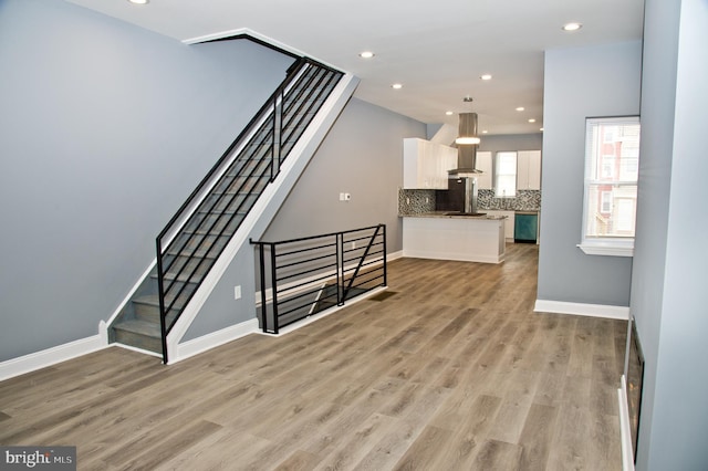 3137 Clifford St, Philadelphia, PA 19121 - unfurnished living room with light wood-style floors, recessed lighting, baseboards, and stairway