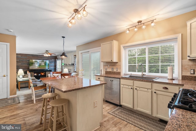 9341 Amaryllis Ave, Manassas, VA 20110 - kitchen featuring dishwasher, a sink, light wood-type flooring, open floor plan, and backsplash