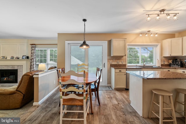 9341 Amaryllis Ave, Manassas, VA 20110 - kitchen featuring tasteful backsplash, plenty of natural light, light wood-style floors, and a fireplace
