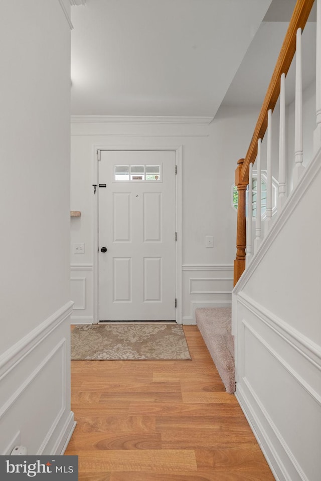 9341 Amaryllis Ave, Manassas, VA 20110 - entrance foyer with stairs, light wood-style flooring, ornamental molding, a decorative wall, and wainscoting