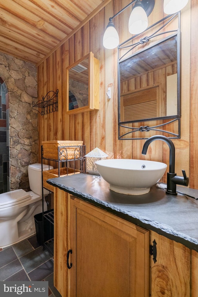 9341 Amaryllis Ave, Manassas, VA 20110 - bathroom with wood ceiling, wood walls, vanity, and toilet