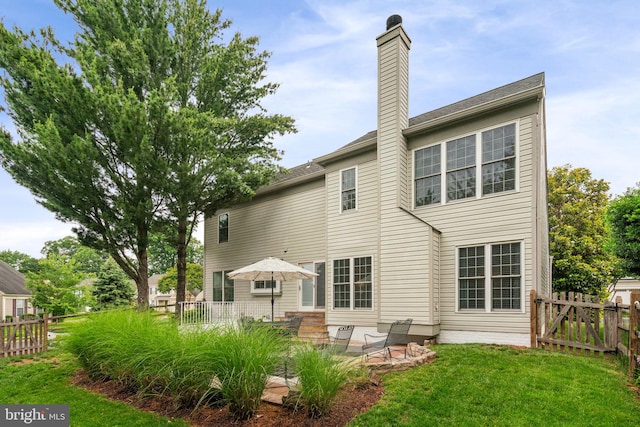 9341 Amaryllis Ave, Manassas, VA 20110 - rear view of house featuring a patio area and a chimney