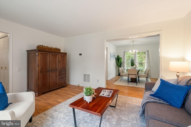 9341 Amaryllis Ave, Manassas, VA 20110 - living area with light wood-style floors and a chandelier