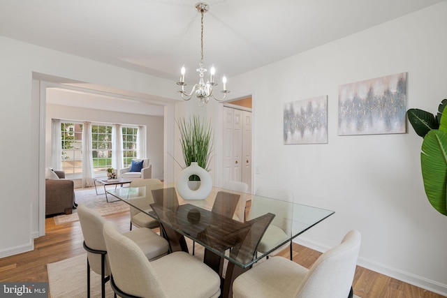 9341 Amaryllis Ave, Manassas, VA 20110 - dining space featuring a chandelier, light wood finished floors, and baseboards