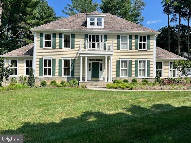 2156 Misty Meadow Rd, Finksburg, MD 21048 - view of front facade featuring a balcony, a front yard, and stone siding