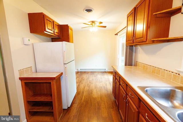 503 Deer Run Rd, Lititz, PA 17543 - kitchen with open shelves, freestanding refrigerator, baseboard heating, and wood finished floors