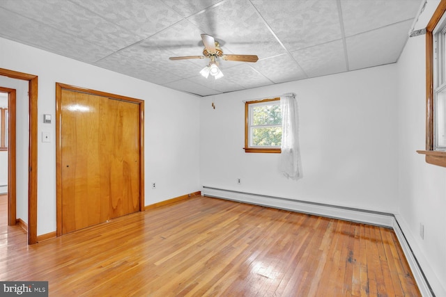 176 Morris Ave, Sewell, NJ 08080 - unfurnished bedroom with a baseboard radiator, hardwood / wood-style floors, baseboards, and a paneled ceiling