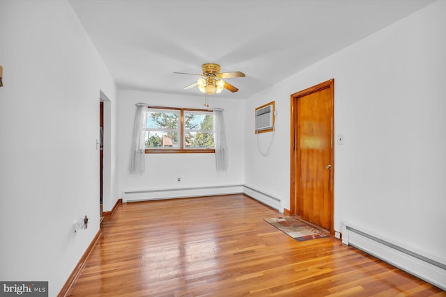 176 Morris Ave, Sewell, NJ 08080 - spare room with a baseboard heating unit, a ceiling fan, light wood-style flooring, and a wall unit AC