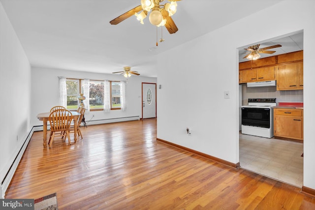 176 Morris Ave, Sewell, NJ 08080 - dining room featuring a baseboard heating unit, a ceiling fan, baseboards, and light wood finished floors