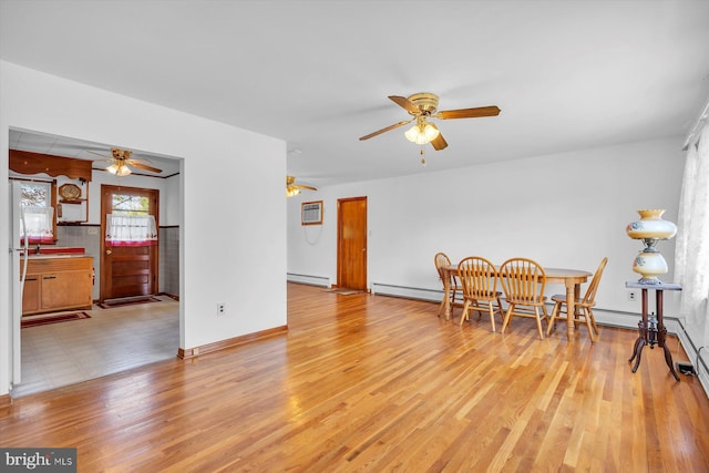 176 Morris Ave, Sewell, NJ 08080 - dining area featuring a baseboard radiator, a ceiling fan, light wood-style floors, and baseboards