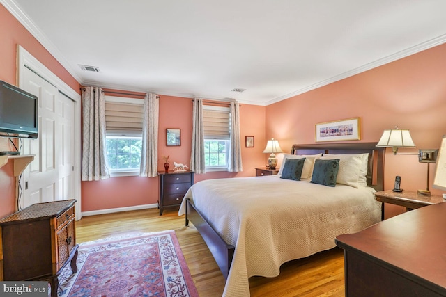 706 6th St SW, Washington, DC 20024 - bedroom featuring ornamental molding, wood finished floors, and baseboards