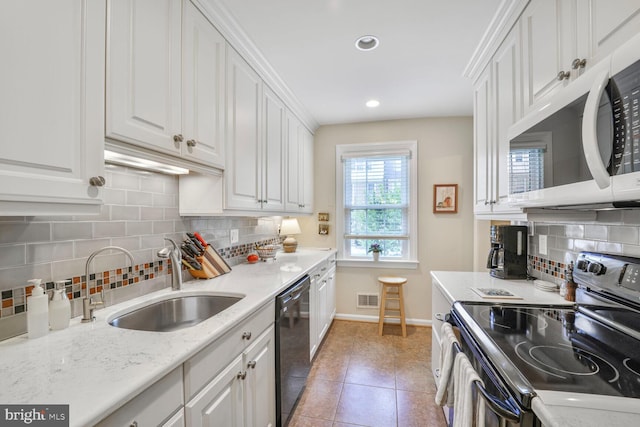 706 6th St SW, Washington, DC 20024 - kitchen with appliances with stainless steel finishes, a sink, white cabinets, baseboards, and recessed lighting