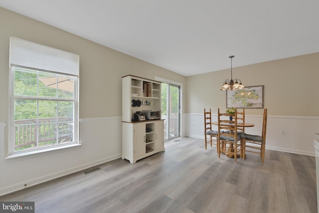 35871 Devon Park Sq, Round Hill, VA 20141 - dining space with wainscoting, light wood-type flooring, and a chandelier