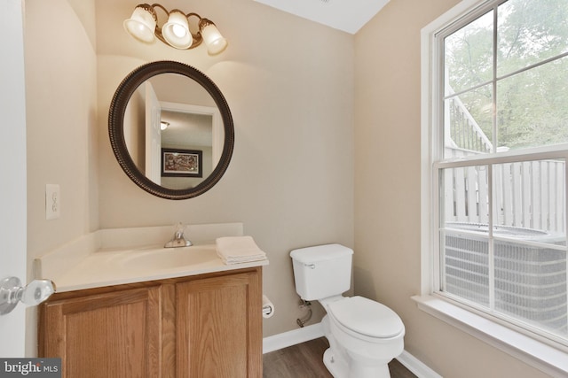 35871 Devon Park Sq, Round Hill, VA 20141 - half bathroom featuring toilet, vanity, baseboards, and wood finished floors