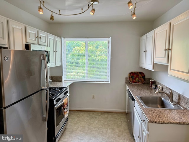 4212 Benning Rd NE Unit 6, Washington, DC 20019 - kitchen with stainless steel appliances, a sink, rail lighting, and baseboards