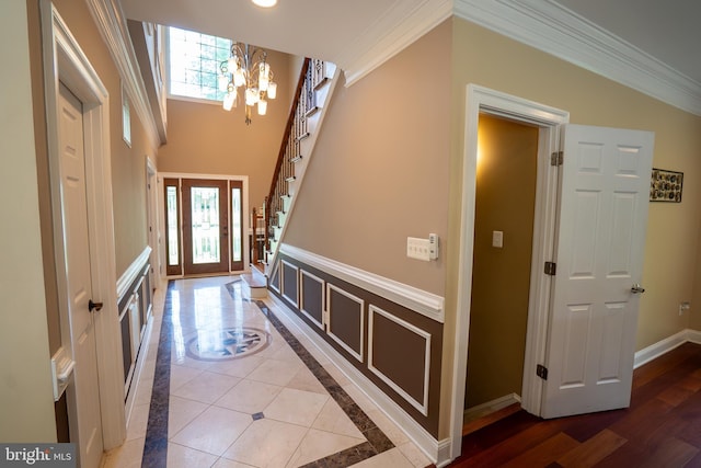 5280 Ten Oaks Rd, Clarksville, MD 21029 - entrance foyer featuring ornamental molding, a chandelier, healthy amount of natural light, stairway, and inlaid floor details
