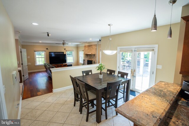 5280 Ten Oaks Rd, Clarksville, MD 21029 - dining area with a brick fireplace, ceiling fan, ornamental molding, light tile patterned floors, and recessed lighting