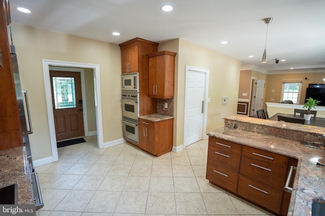 5280 Ten Oaks Rd, Clarksville, MD 21029 - kitchen with appliances with stainless steel finishes, brown cabinetry, light stone counters, decorative light fixtures, and recessed lighting