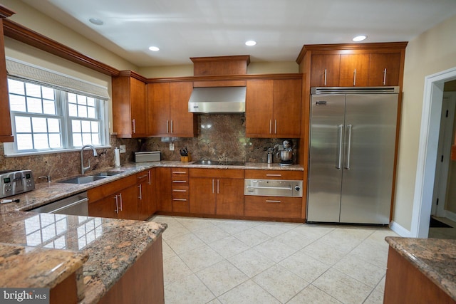 5280 Ten Oaks Rd, Clarksville, MD 21029 - kitchen featuring stainless steel appliances, wall chimney exhaust hood, a warming drawer, brown cabinets, and tasteful backsplash