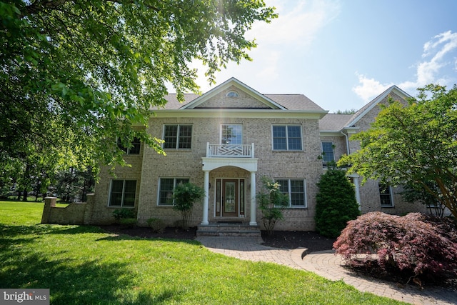 5280 Ten Oaks Rd, Clarksville, MD 21029 - colonial house featuring a front yard, a balcony, and brick siding