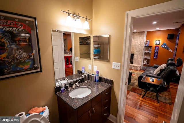 5280 Ten Oaks Rd, Clarksville, MD 21029 - bathroom with vanity, wood finished floors, recessed lighting, and a fireplace