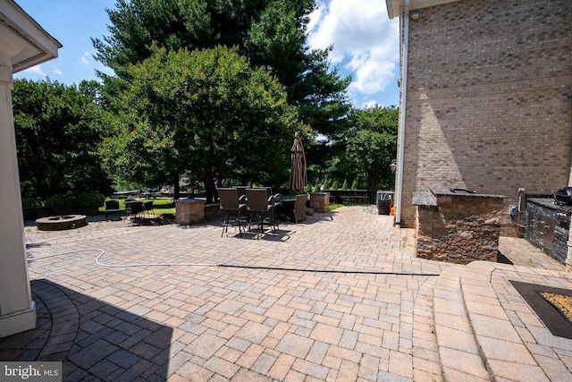 5280 Ten Oaks Rd, Clarksville, MD 21029 - view of patio featuring an outdoor fire pit, outdoor dining space, and exterior kitchen