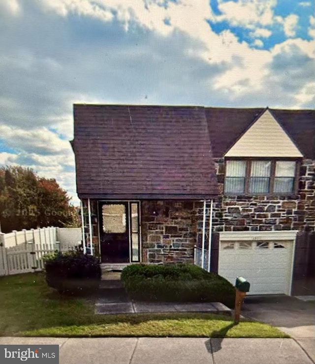 15111 Ina Dr, Philadelphia, PA 19116 - view of front of house with concrete driveway, an attached garage, and stone siding