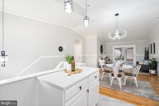 15 Charleswood Ct, Baltimore, MD 21207 - kitchen featuring white cabinetry, hanging light fixtures, light countertops, a chandelier, and light wood-type flooring