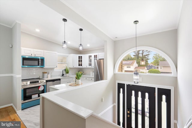 15 Charleswood Ct, Baltimore, MD 21207 - kitchen with stainless steel appliances, healthy amount of natural light, light countertops, white cabinetry, and crown molding
