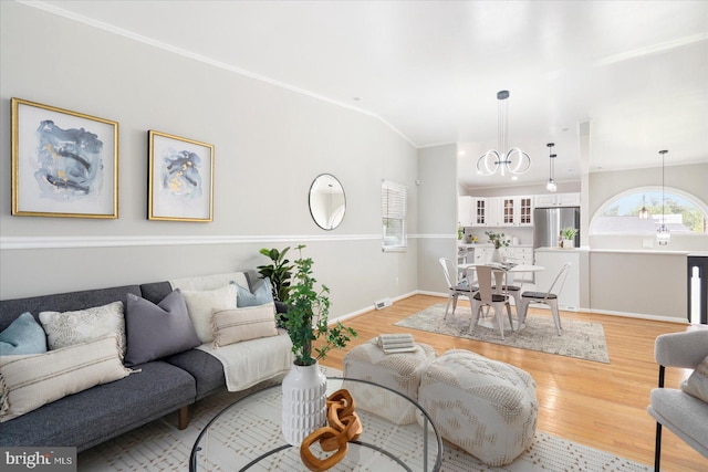 15 Charleswood Ct, Baltimore, MD 21207 - living room with a chandelier, light wood-style flooring, ornamental molding, and baseboards