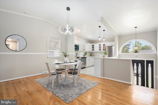 15 Charleswood Ct, Baltimore, MD 21207 - dining area featuring light wood finished floors, baseboards, a chandelier, crown molding, and high vaulted ceiling