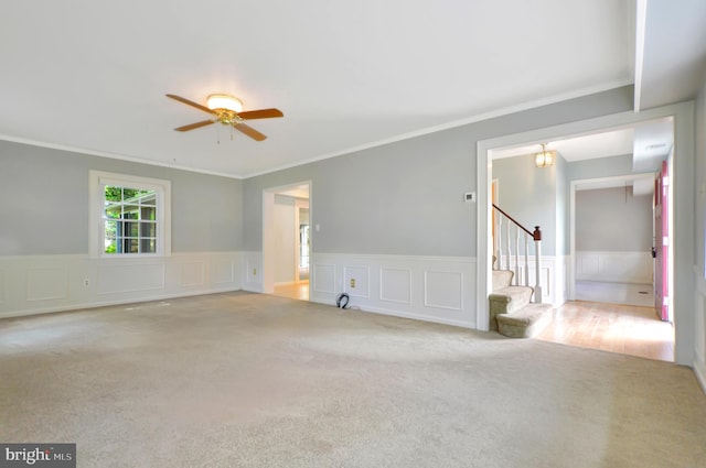 12110 Wilmont Turn, Bowie, MD 20715 - spare room featuring carpet flooring, stairway, crown molding, a ceiling fan, and a wainscoted wall
