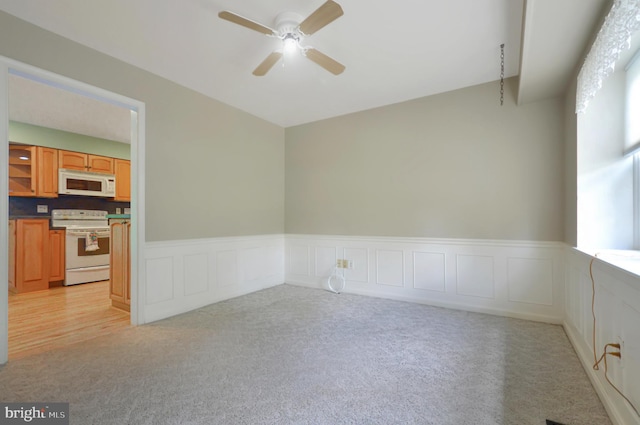 12110 Wilmont Turn, Bowie, MD 20715 - empty room with a ceiling fan, light carpet, wainscoting, and a decorative wall
