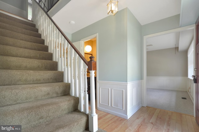 12110 Wilmont Turn, Bowie, MD 20715 - staircase with hardwood / wood-style floors, a wainscoted wall, and a decorative wall