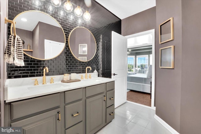 21668 Pattyjean Ter Unit 0, Ashburn, VA 20147 - full bathroom featuring connected bathroom, double vanity, tile patterned flooring, and baseboards