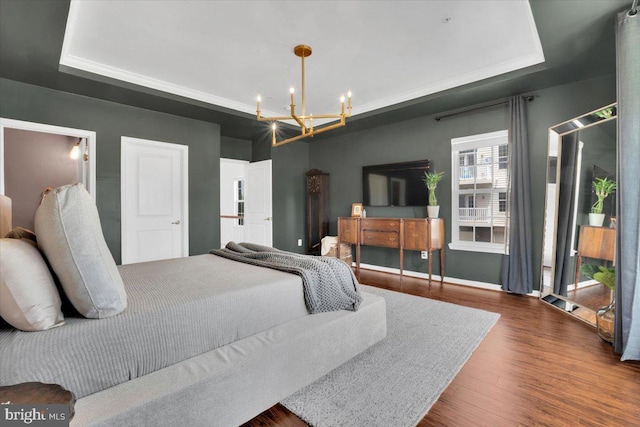 21668 Pattyjean Ter Unit 0, Ashburn, VA 20147 - bedroom with a tray ceiling, a chandelier, dark wood finished floors, and baseboards