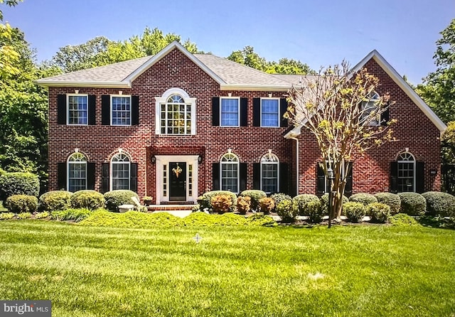 8921 Grotto Ct, Pomfret, MD 20675 - view of front of property featuring a front yard, brick siding, and roof with shingles