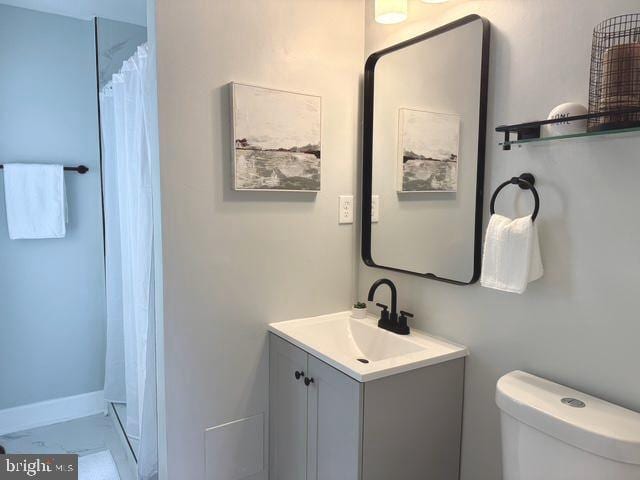 2621 E Monument St, Baltimore, MD 21205 - bathroom with vanity, toilet, and a shower with curtain