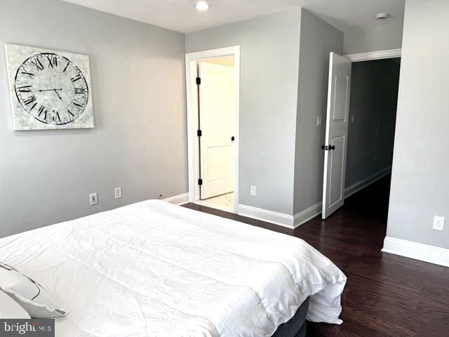 2621 E Monument St, Baltimore, MD 21205 - bedroom featuring wood finished floors, baseboards, and recessed lighting