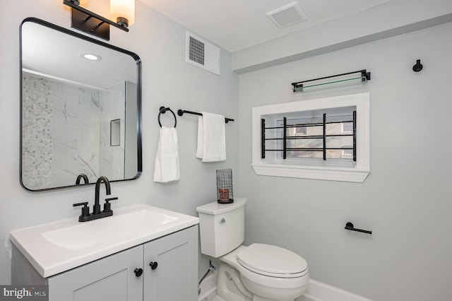 2621 E Monument St, Baltimore, MD 21205 - bathroom featuring a marble finish shower, vanity, toilet, and baseboards