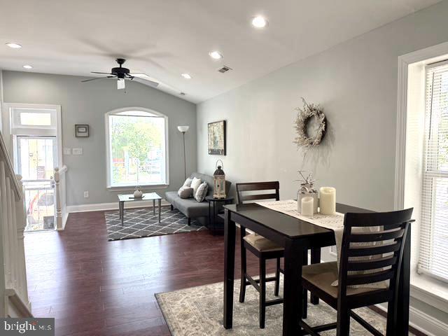 2621 E Monument St, Baltimore, MD 21205 - dining room featuring dark wood-type flooring, healthy amount of natural light, ceiling fan, lofted ceiling, and baseboards
