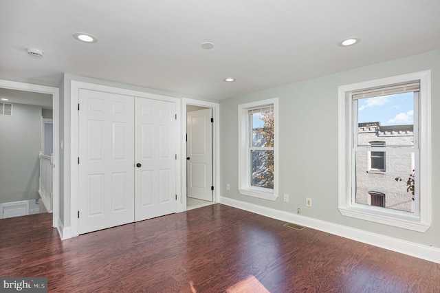 2621 E Monument St, Baltimore, MD 21205 - unfurnished bedroom featuring wood finished floors, baseboards, a closet, and recessed lighting