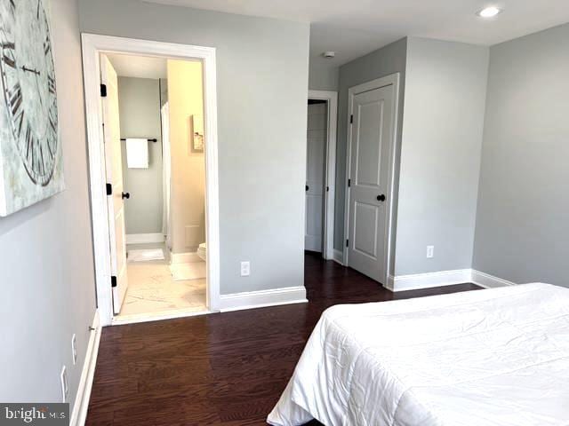 2621 E Monument St, Baltimore, MD 21205 - bedroom featuring wood finished floors, baseboards, recessed lighting, and connected bathroom
