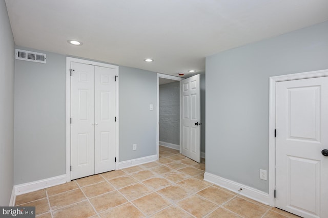 2621 E Monument St, Baltimore, MD 21205 - unfurnished bedroom with recessed lighting, baseboards, light tile patterned flooring, and a closet